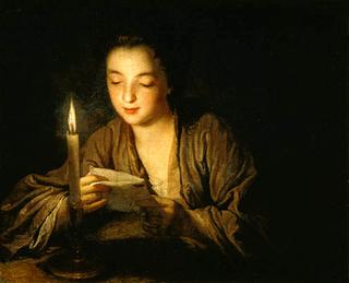 Girl reading a letter by candlelight