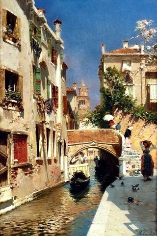 A woman carrying water beside a Venetian canal