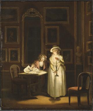 Two women inspecting a picture by candle-light