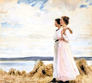 Two young girls walking on the coast
