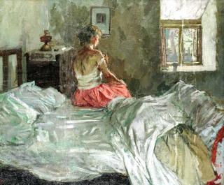 Lady seated on a bed
