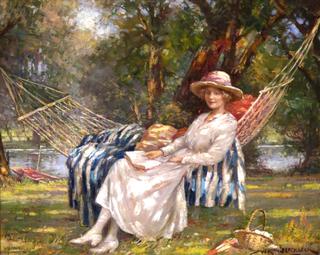 A lady reclining in a hammock by the river