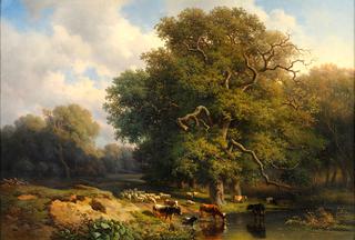 Wooded landscape with lake and grazing cattle