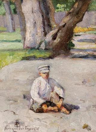 Boy sitting in front of a tree