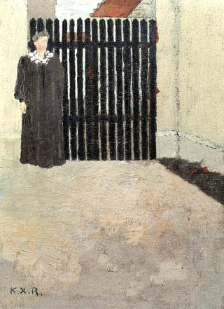 Woman in front of a Green Gate