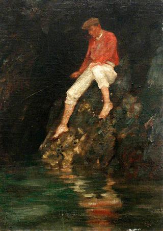 在岩石上钓鱼的男孩