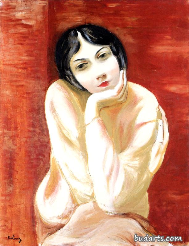 坐在砖背景上的女人