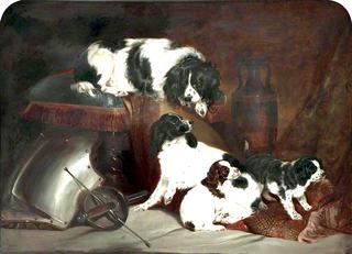 两只查尔斯国王的猎犬和它们的小狗