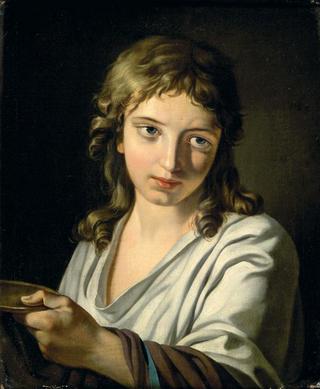 A young boy holding a dish
