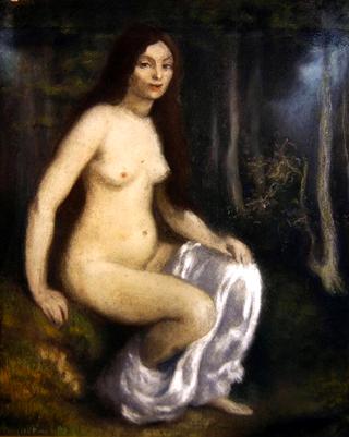 Young woman seated in a forest