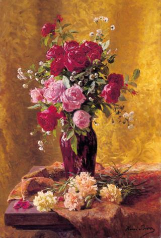 A vase of roses with carnations on a draped table