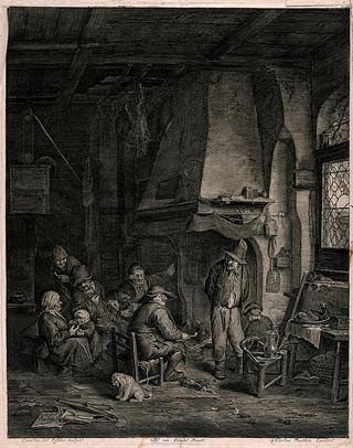 A family gather indoors round a large open fireplace