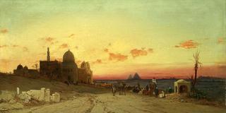 A view of the tomb of the caliphs with the Giza pyramids beyond
