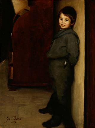 Smiling boy at a wall
