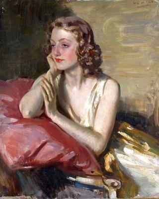 Portrait of Rai resting on a pink cushion