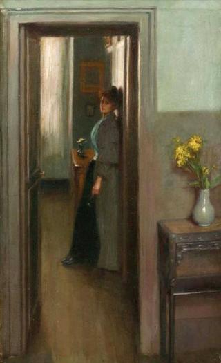 A woman standing in a doorway of an interior