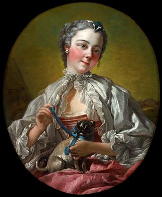A Young Lady Holding a Pug Dog