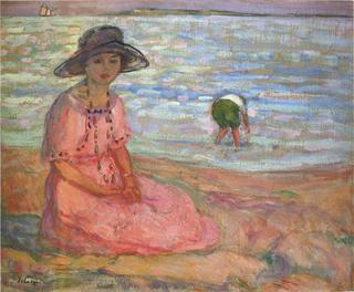 A girl in a pink robe by the sea