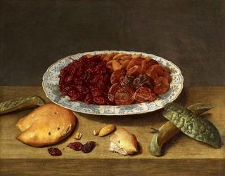 Still life with raisins, apricots and plums in a porcelain dish