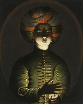 A young girl wearing a turban and holding a candle