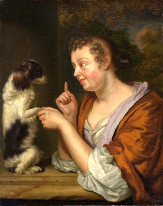 A young lady playing with a dog