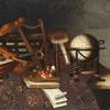 A painter's palette and brushes, musical instruments, books, a globe and two chests, on a table partly draped with a carpet